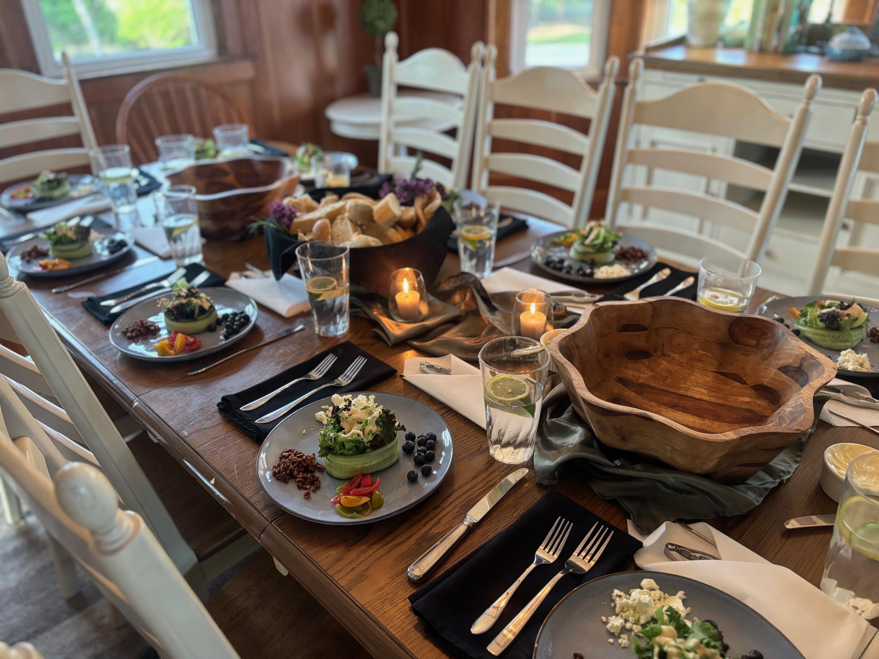 A private chef plating a gourmet, chef-driven dinner for an intimate home gathering or vacation rental in Southern New Hampshire.
