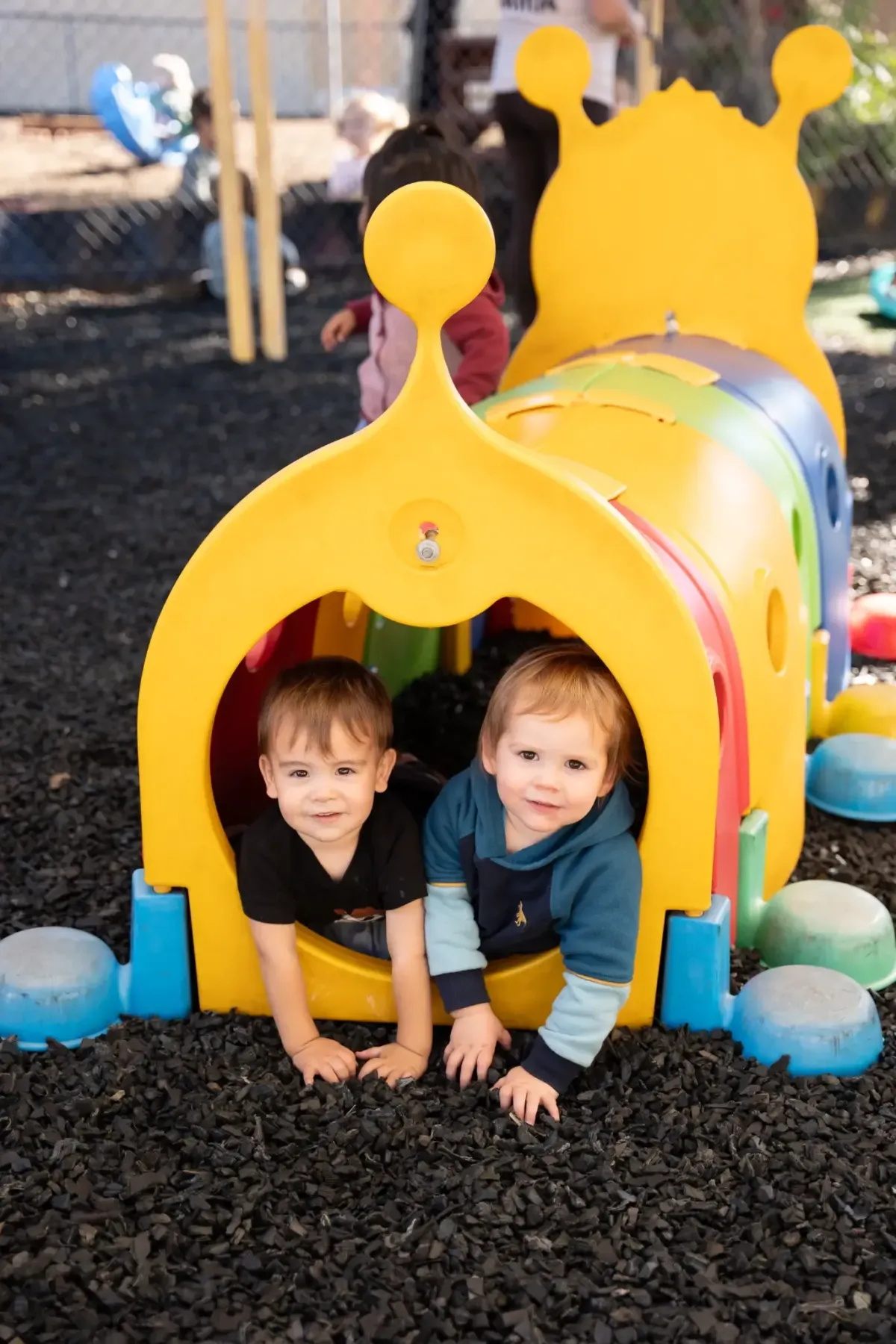 Children playing on the shaded playground at Ready Set Grow Learning Center El Cajon