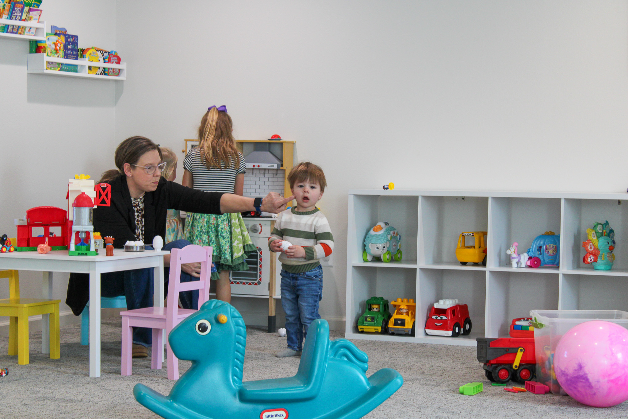 boy in blue and black polo shirt standing beside boy in blue and orange t-shirt