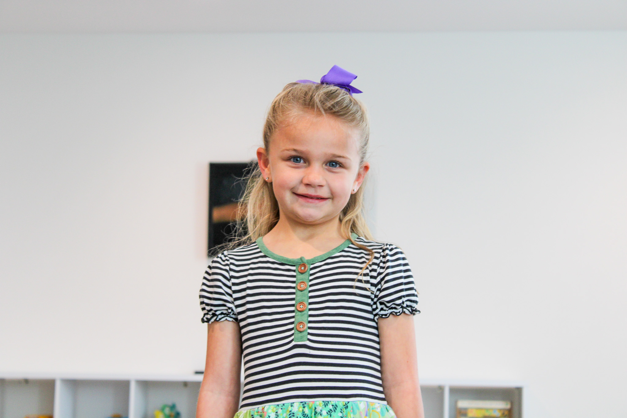 silhouette of child sitting behind tree during sunset