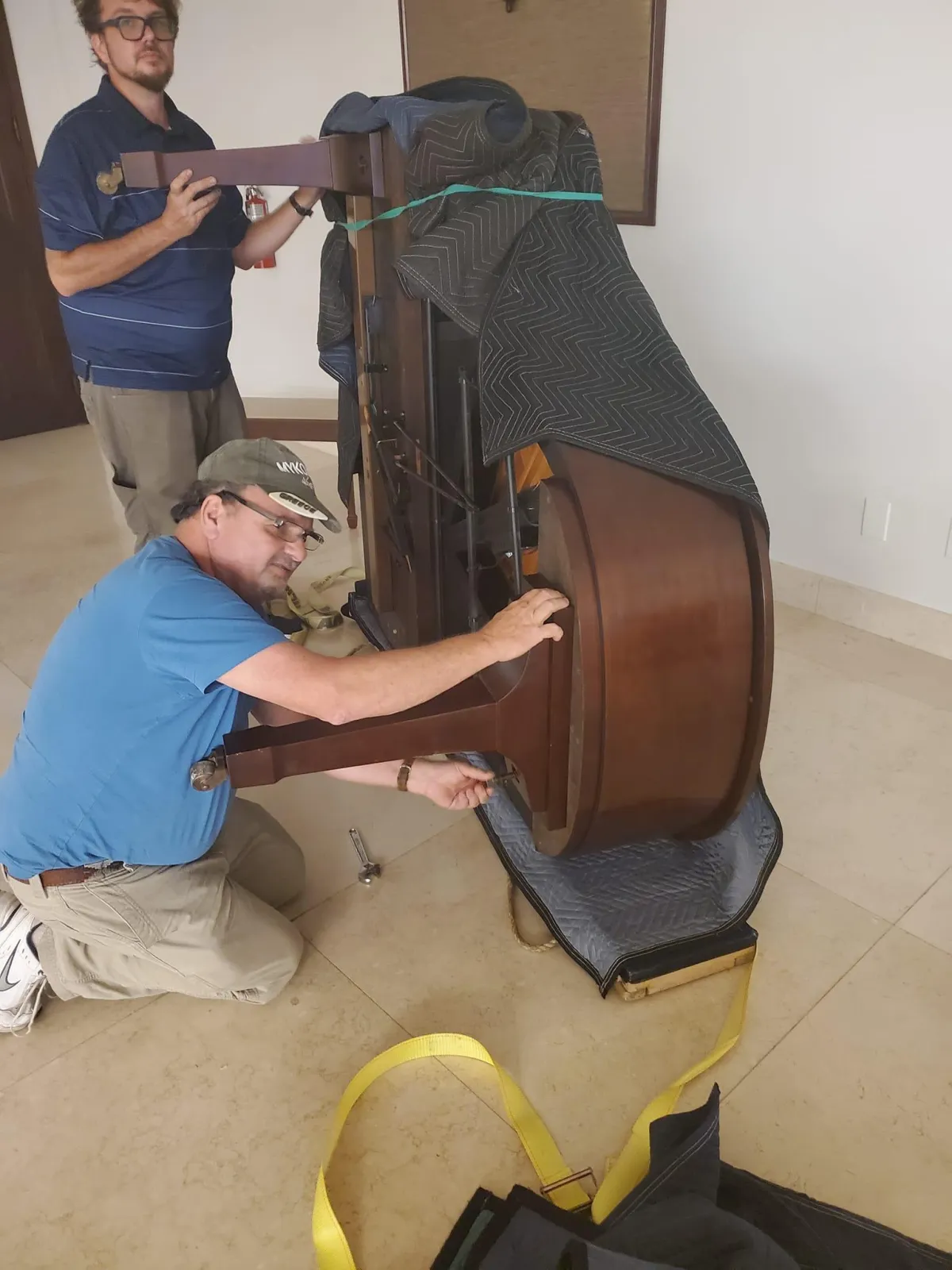 Inside of a grand piano reveals strings and structure.