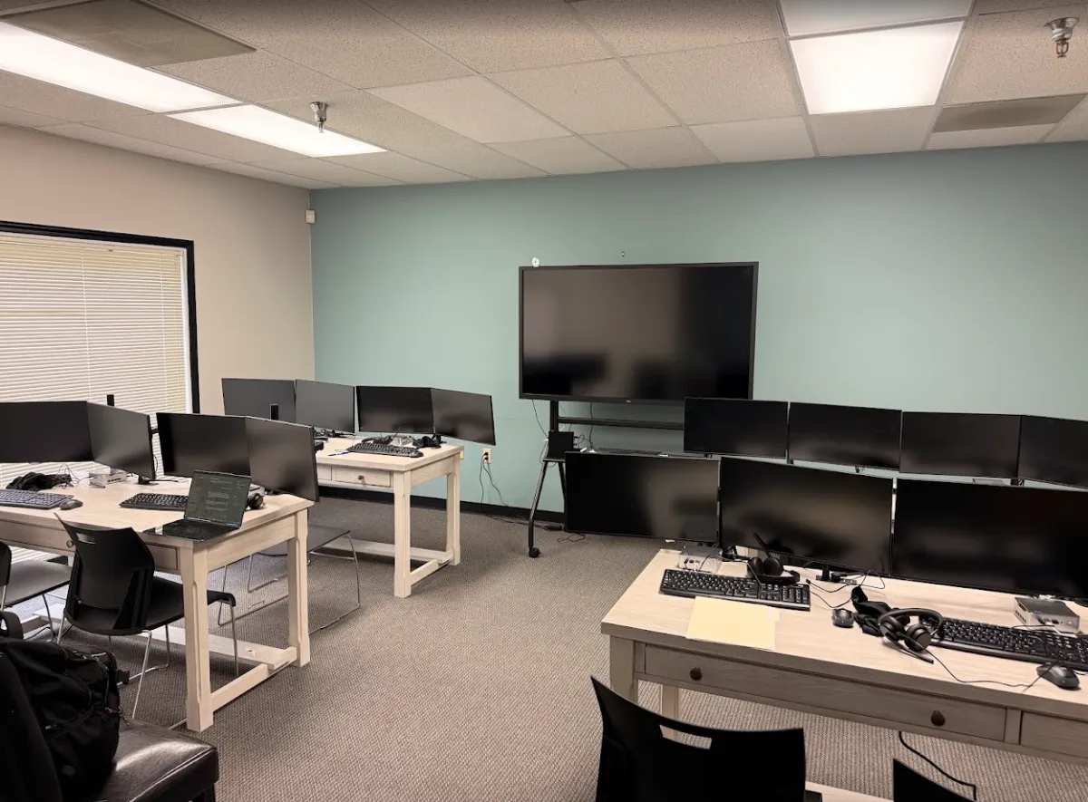 Participants at computers in the SWD AI Lab learning digital skills
