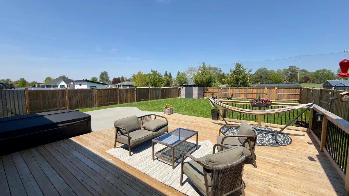 Sunlit wrap-around front porch at 213 Leitch St welcoming private tour visitors