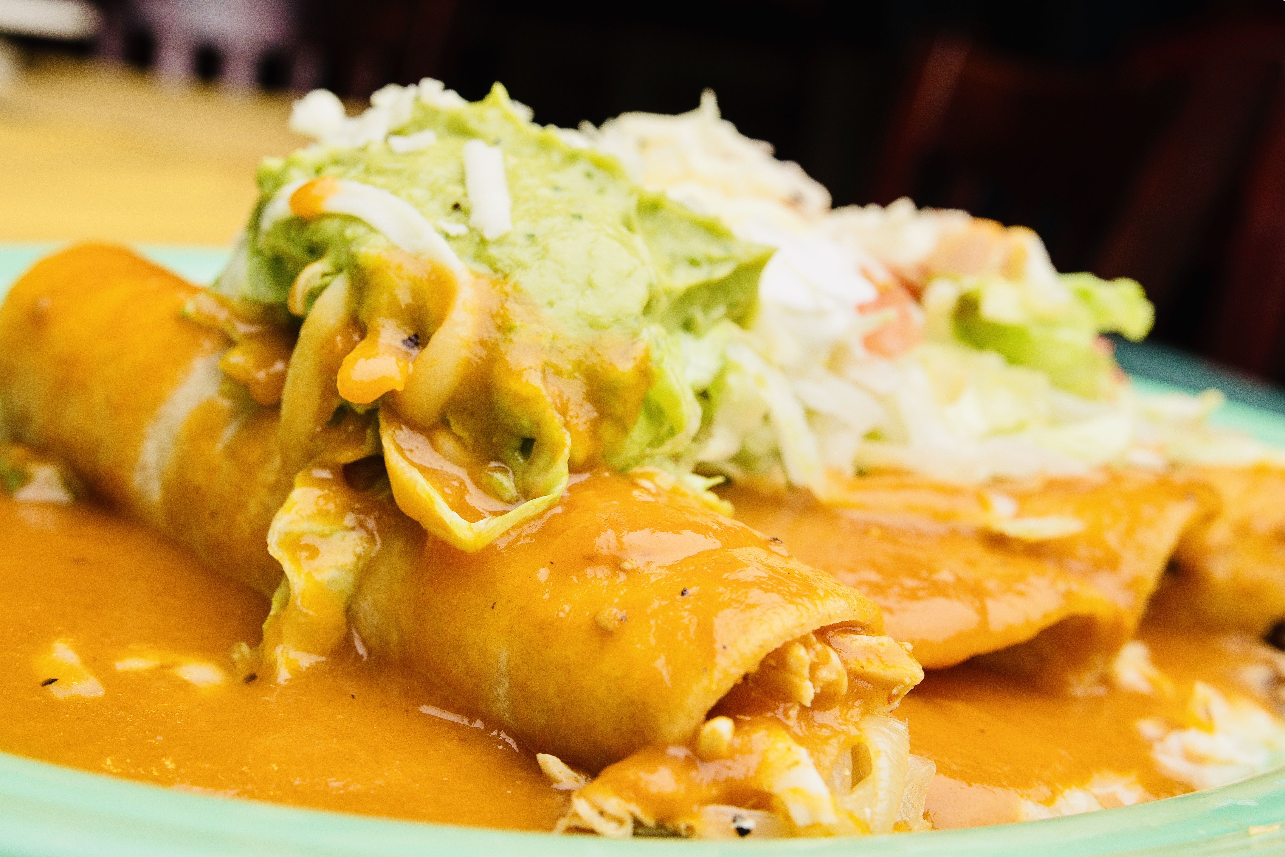 Landscape photo of a takeout package with branded wrapping and a boxed order of sizzling carne asada fajitas next to disposable utensils, crisp natural light, clean composition to indicate convenient online pickup.