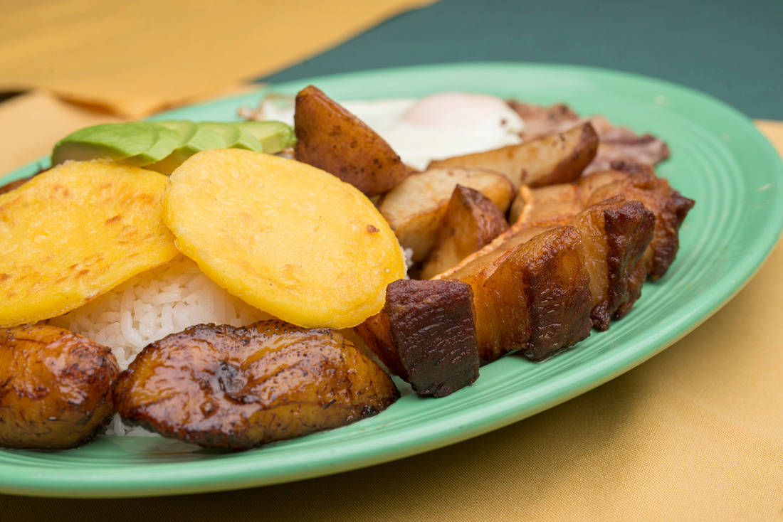 Charred bell peppers and onions on a hot skillet with glistening juices.