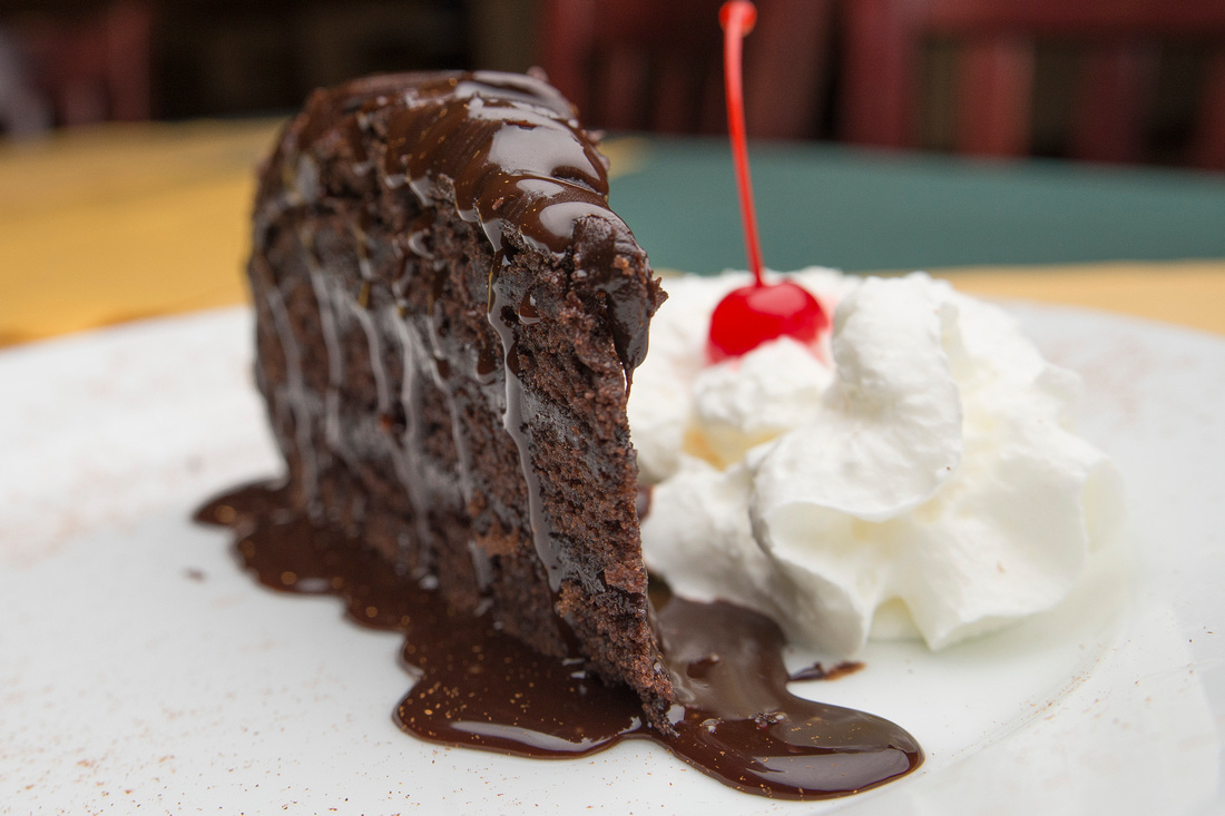 Vegetarian fajita plate with charred zucchini, mushrooms, and peppers arranged colorfully.