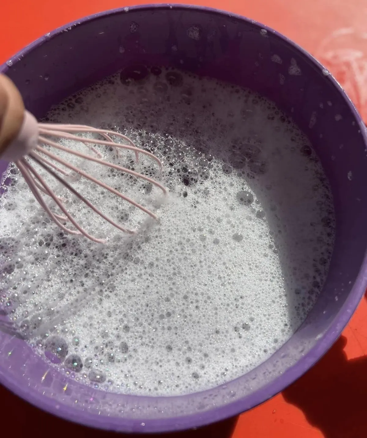 Boy picks paper out of different colored liquids