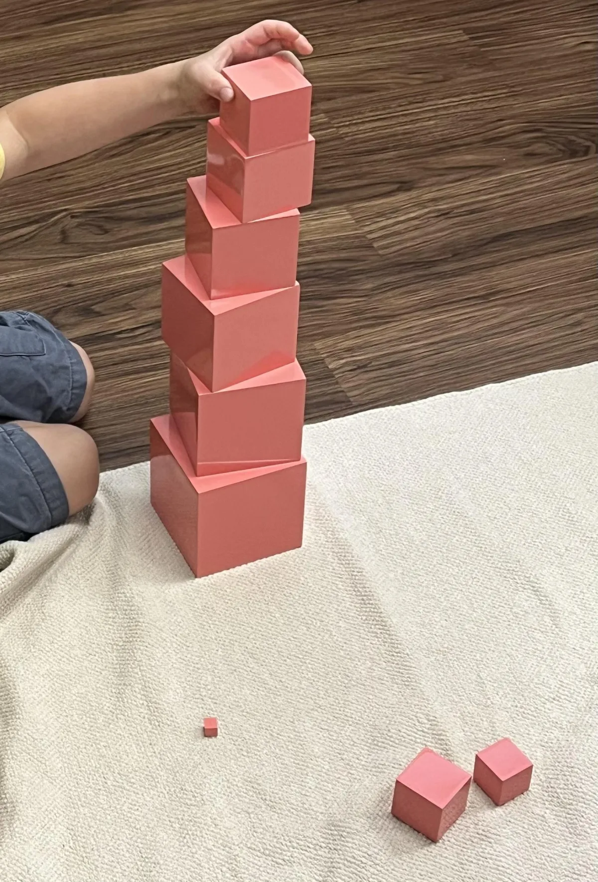 Girl stretches to the side while watching teacher on large screen TV