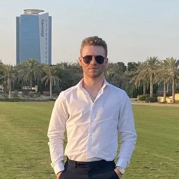 Marketing executive standing in front of a building in Dubai