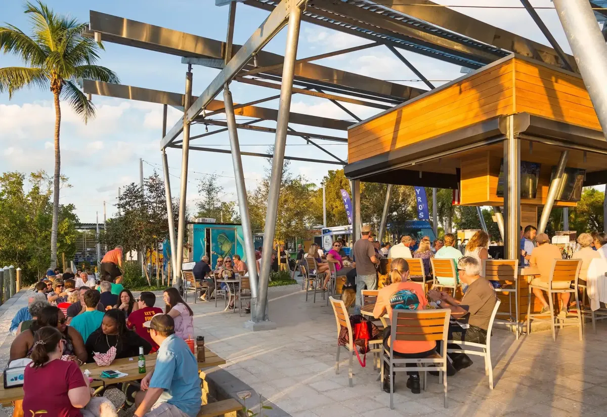 White castle-like building with manicured gardens and car.