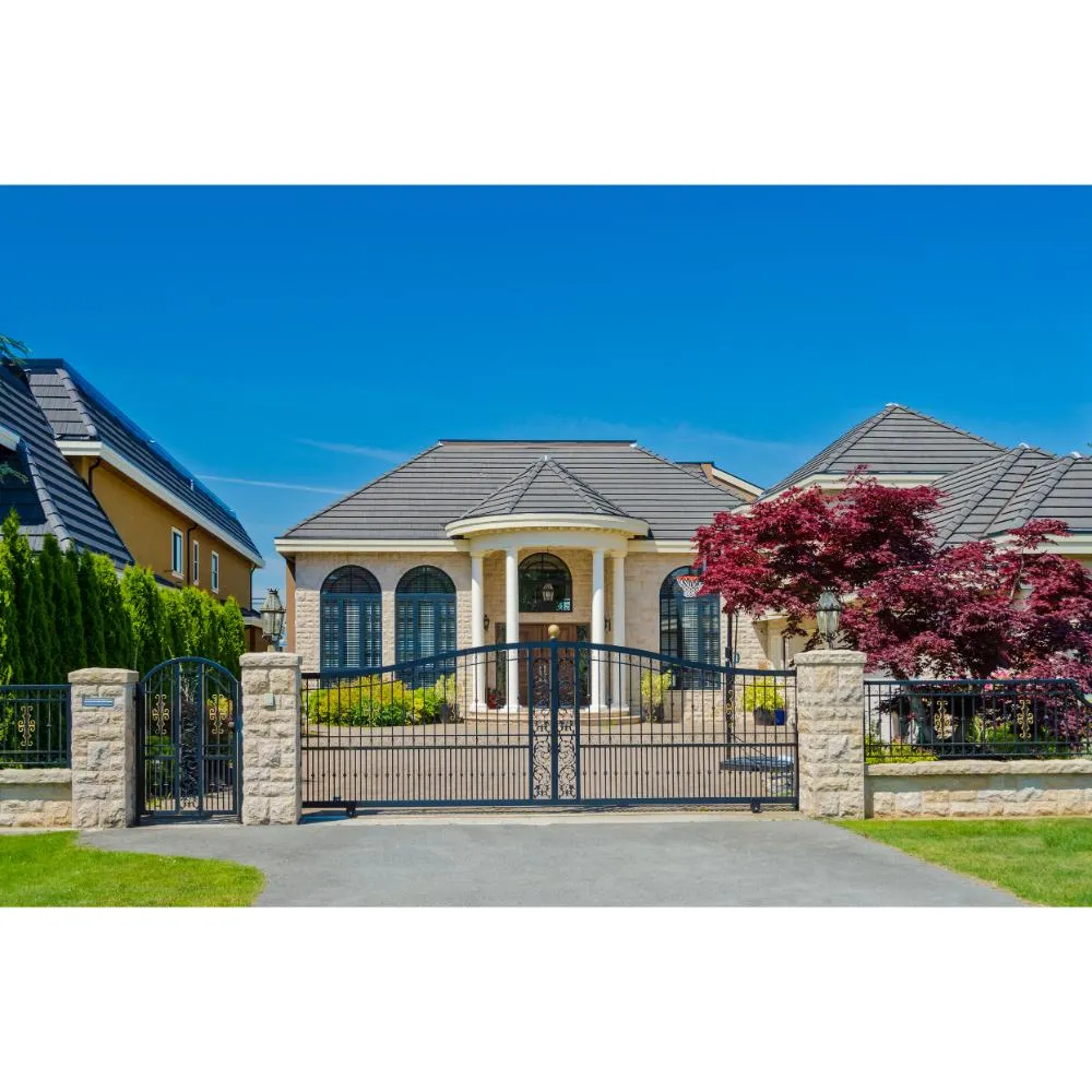 Steel driveway gate with masonry pillars — residential welding, DFW.