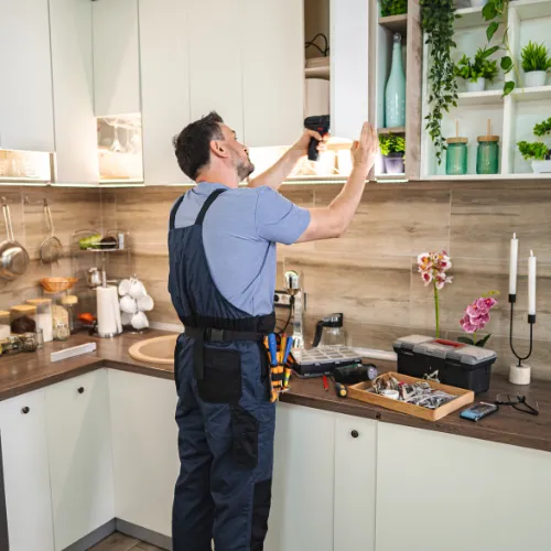 Austin Handyman measuring for counter installation.