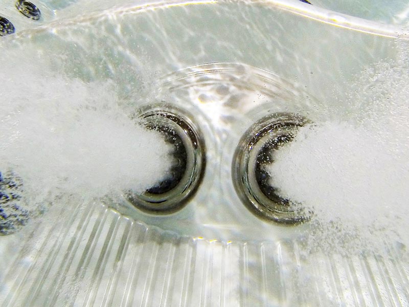 A large white building sitting on the side of a body of water