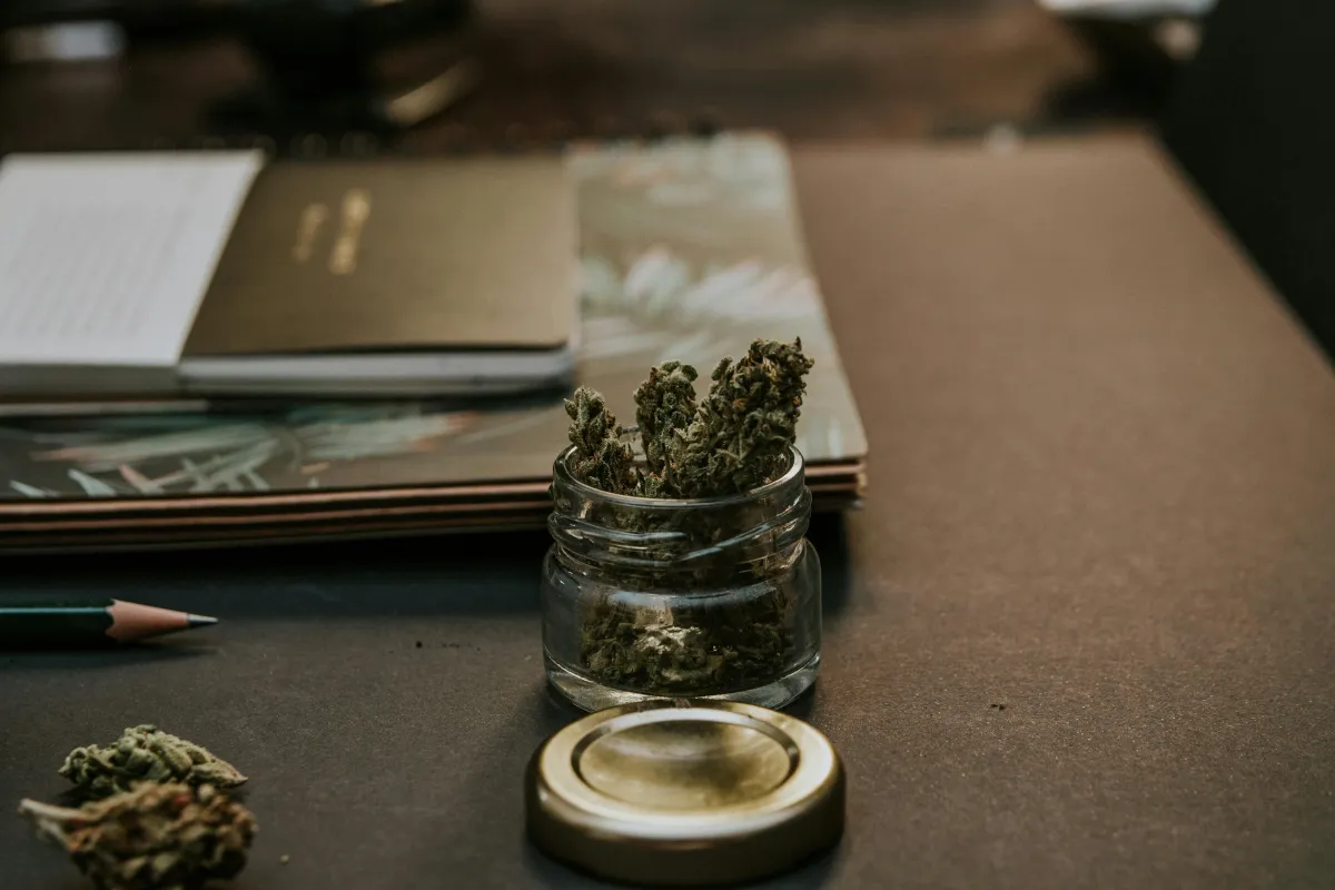 a cannabis product next to notebooks