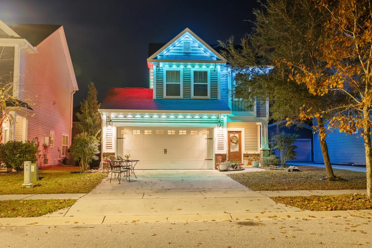 Two-story house featuring cool blue and white EverBright permanent LED lights on the roofline, enhancing curb appeal.