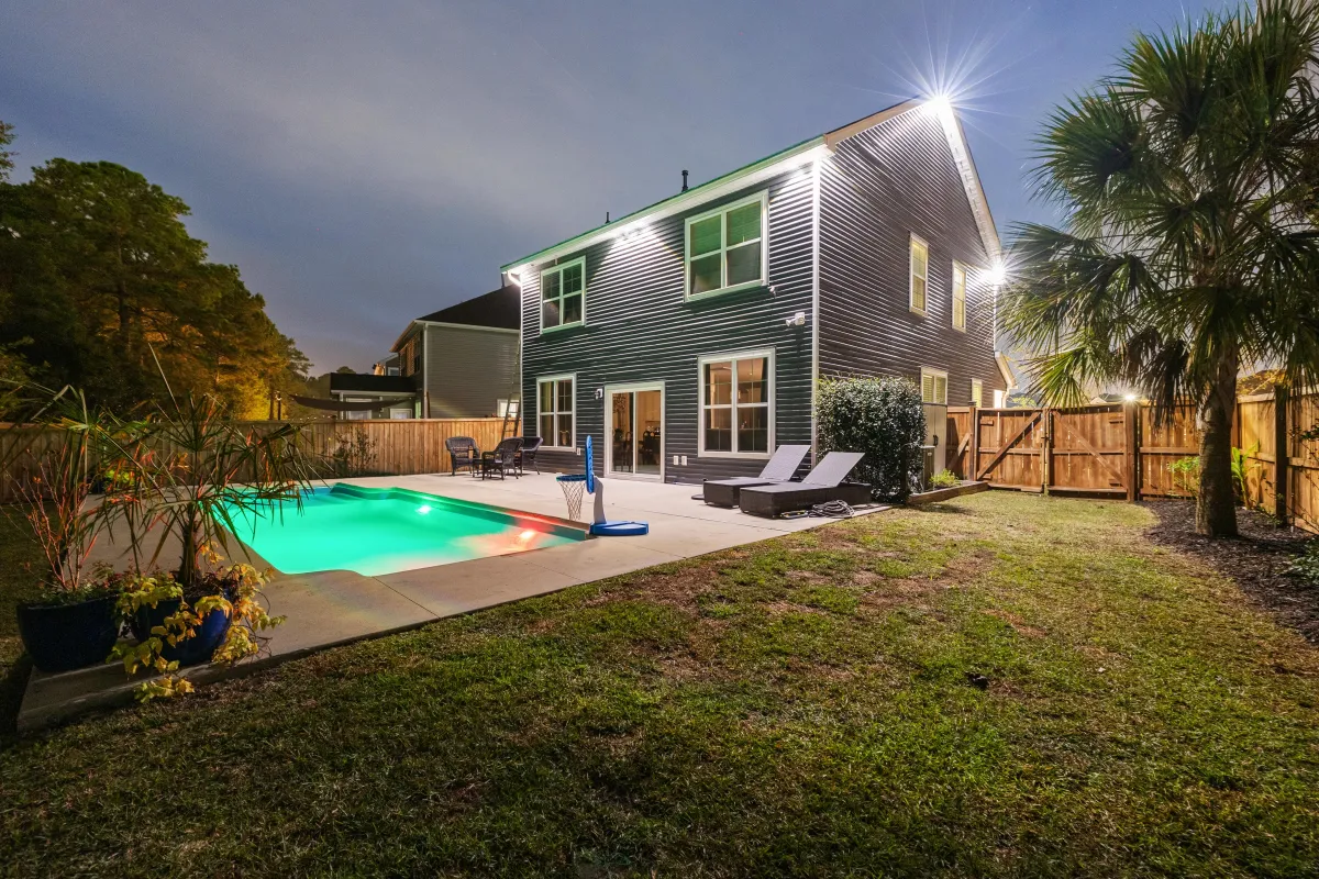 Backyard with EverBright Permanent Lights providing soft illumination around a pool and patio area, offering energy-efficient and customizable lighting for security and ambiance.