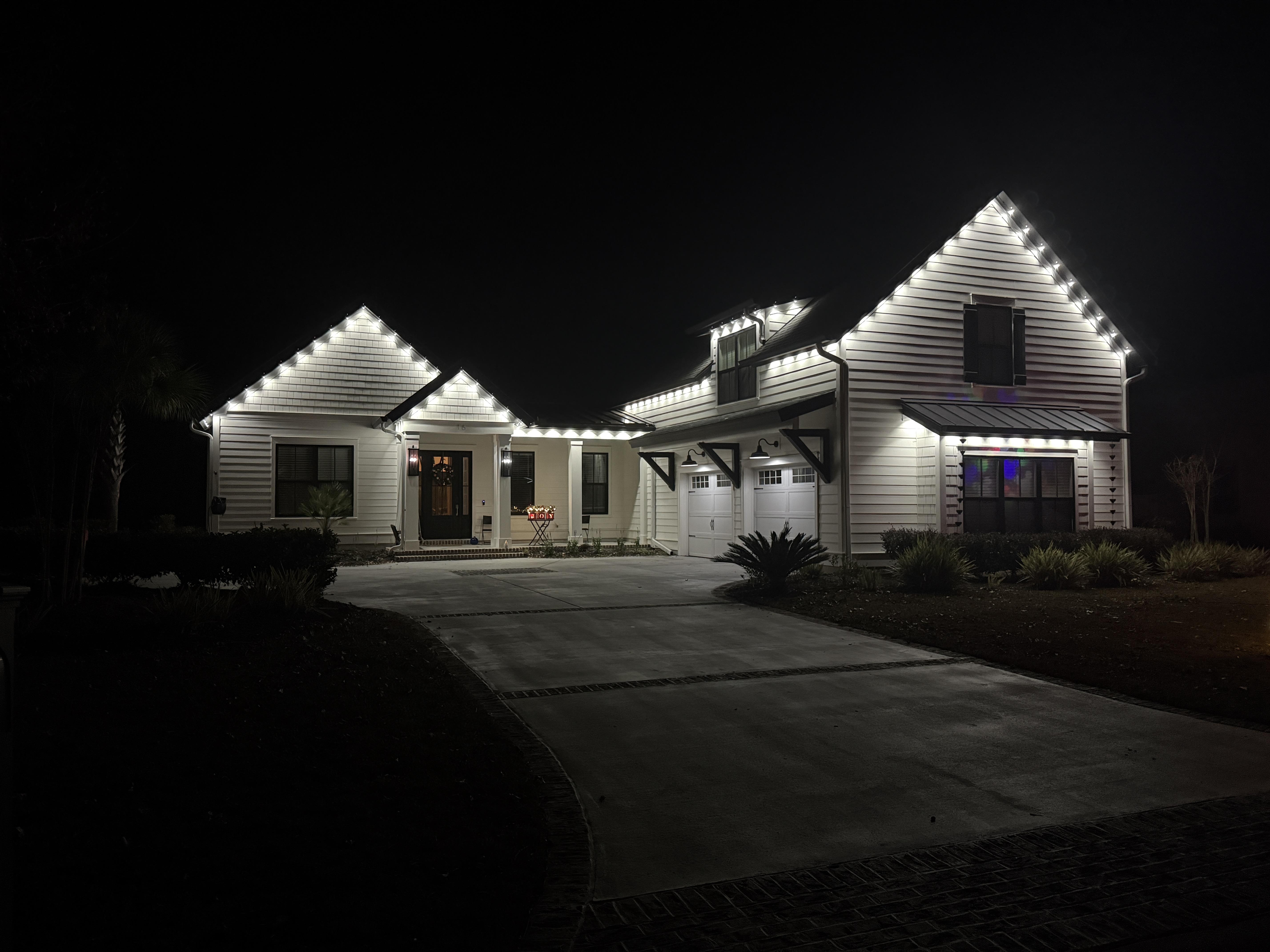Brightly lit house showcasing EverBright Permanent Lights with customizable colors, enhancing the home’s exterior for year-round and holiday lighting.