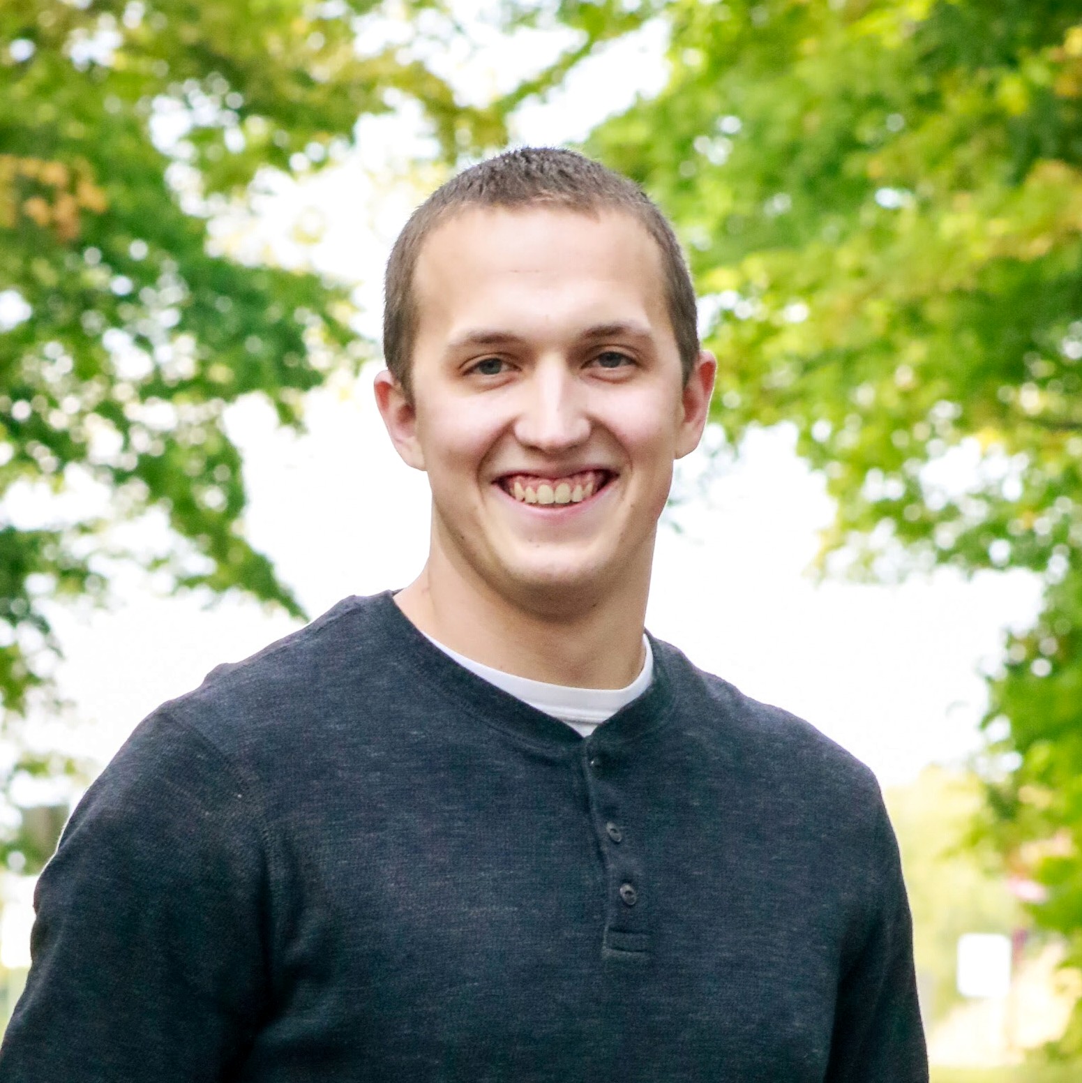 A 1:1 portrait of a middle-aged VFX artist with expressive features, wearing casual attire, standing in front of a blurred editing suite, confident and approachable, soft lighting, no visible branding, focus on personality and expertise.