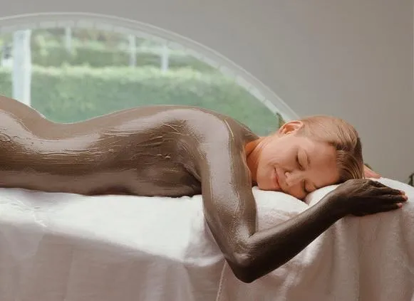 a person riding a snowboard down a snow covered slope