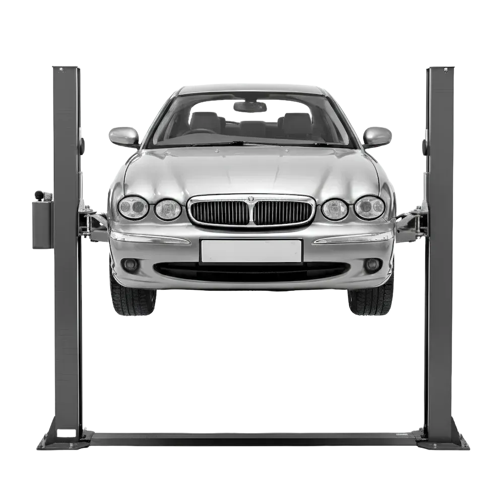 A silver car on a 2 post ramp lift
