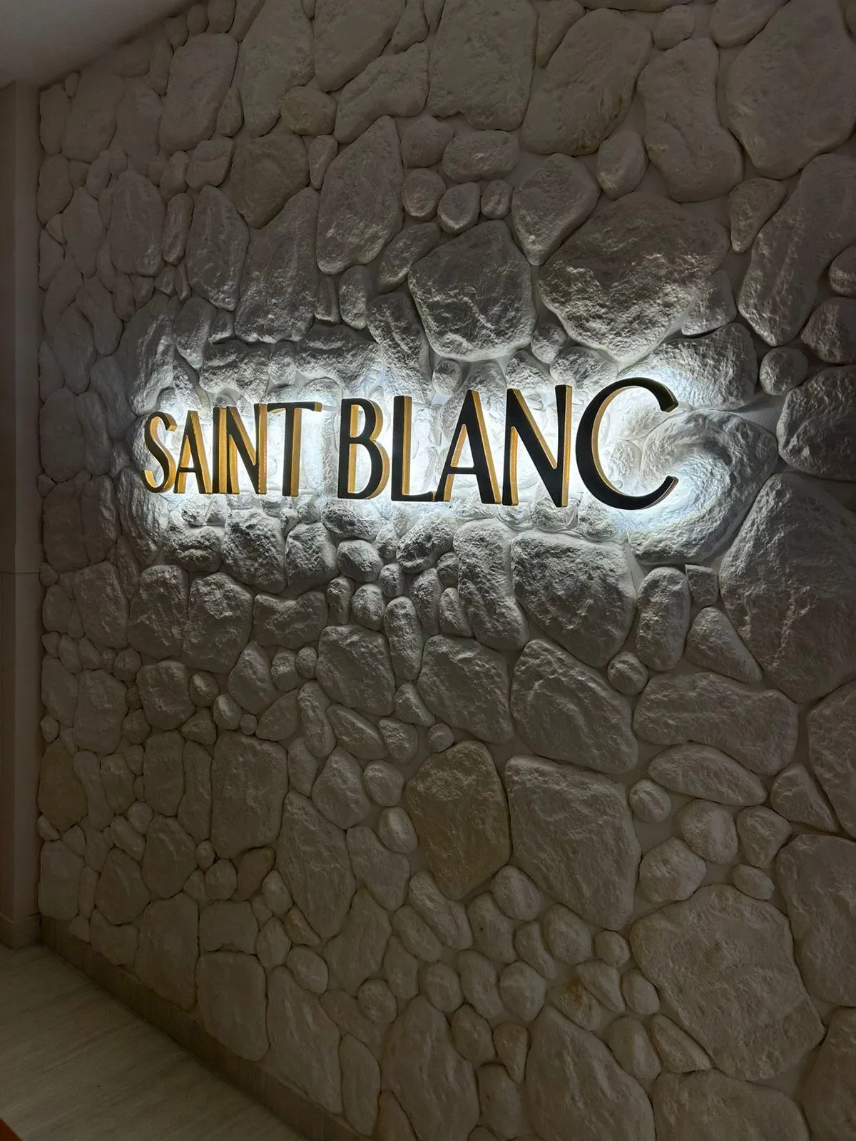 A bride and groom pose in a floral wedding setting