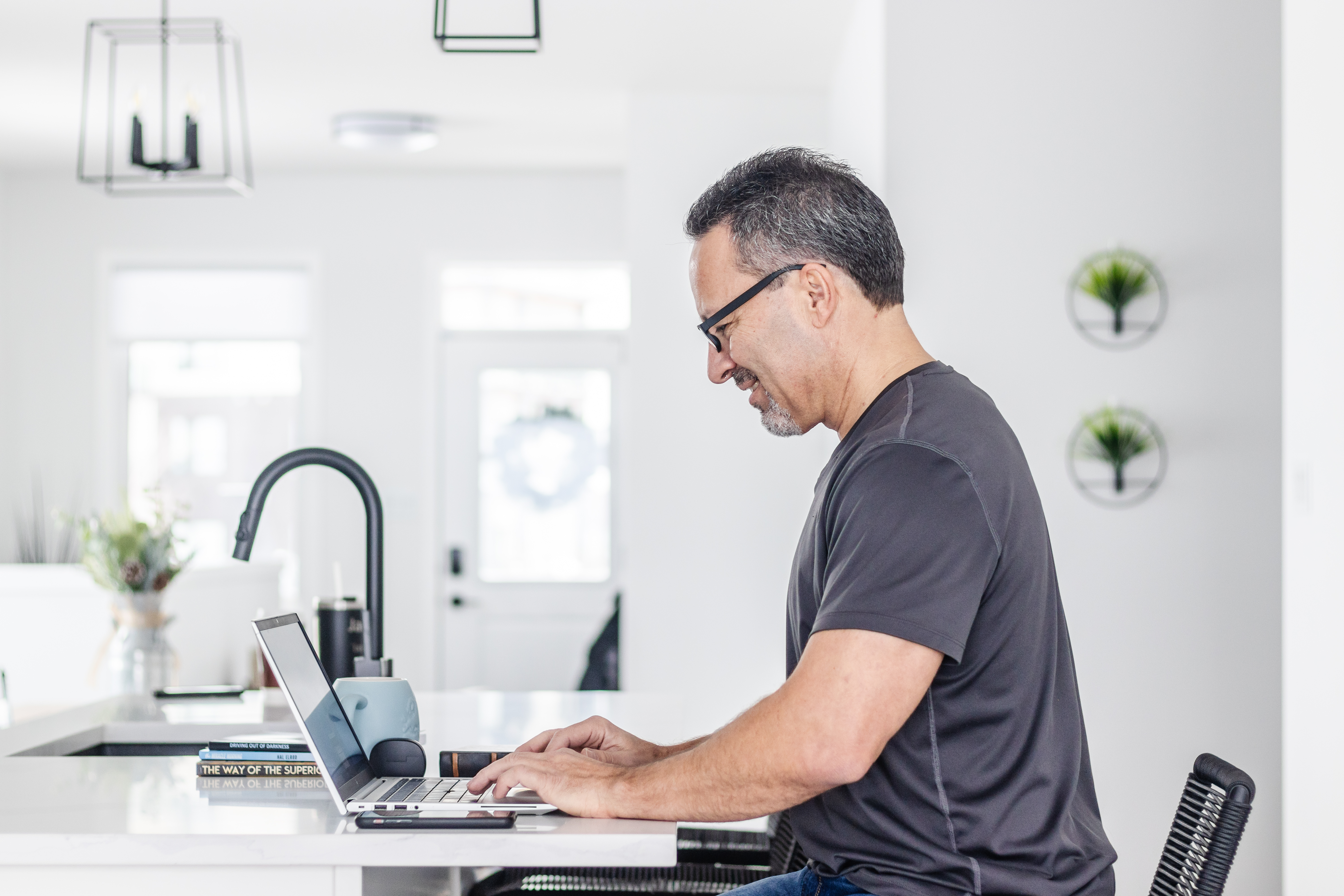 A young adult, focused and energised, sits at a sunlit desk with an open eBook, surrounded by classic study materials and a cup of tea. The background is a blend of deep blue and gold, evoking a sense of timeless learning and ambition.