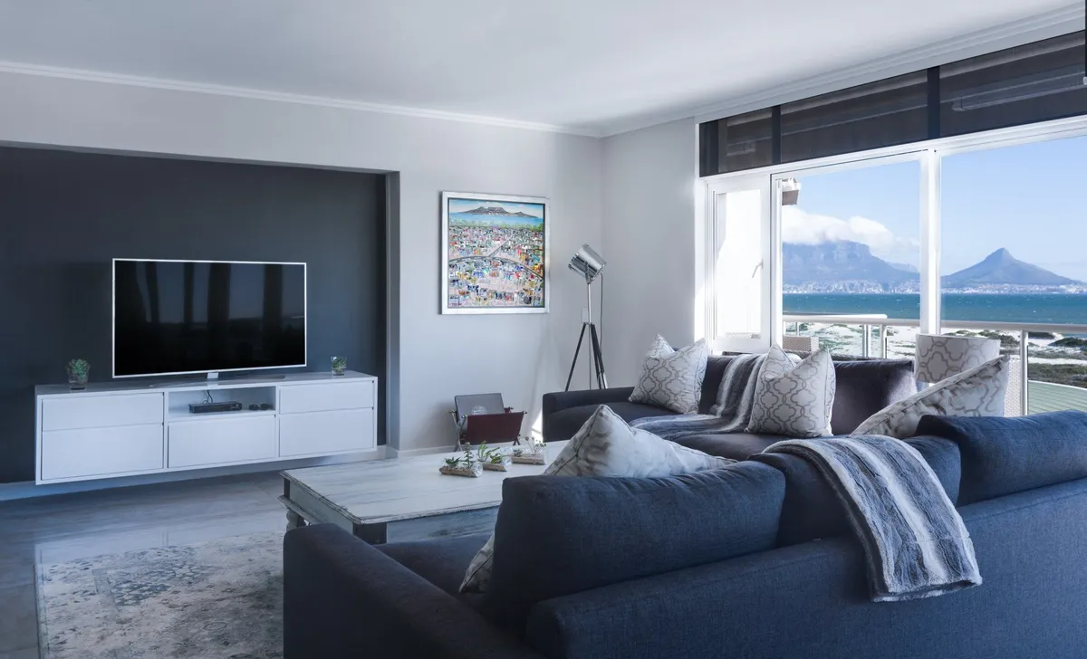 Living room with a gray sectional sofa and wall-mounted TV in a Lubbock, TX home