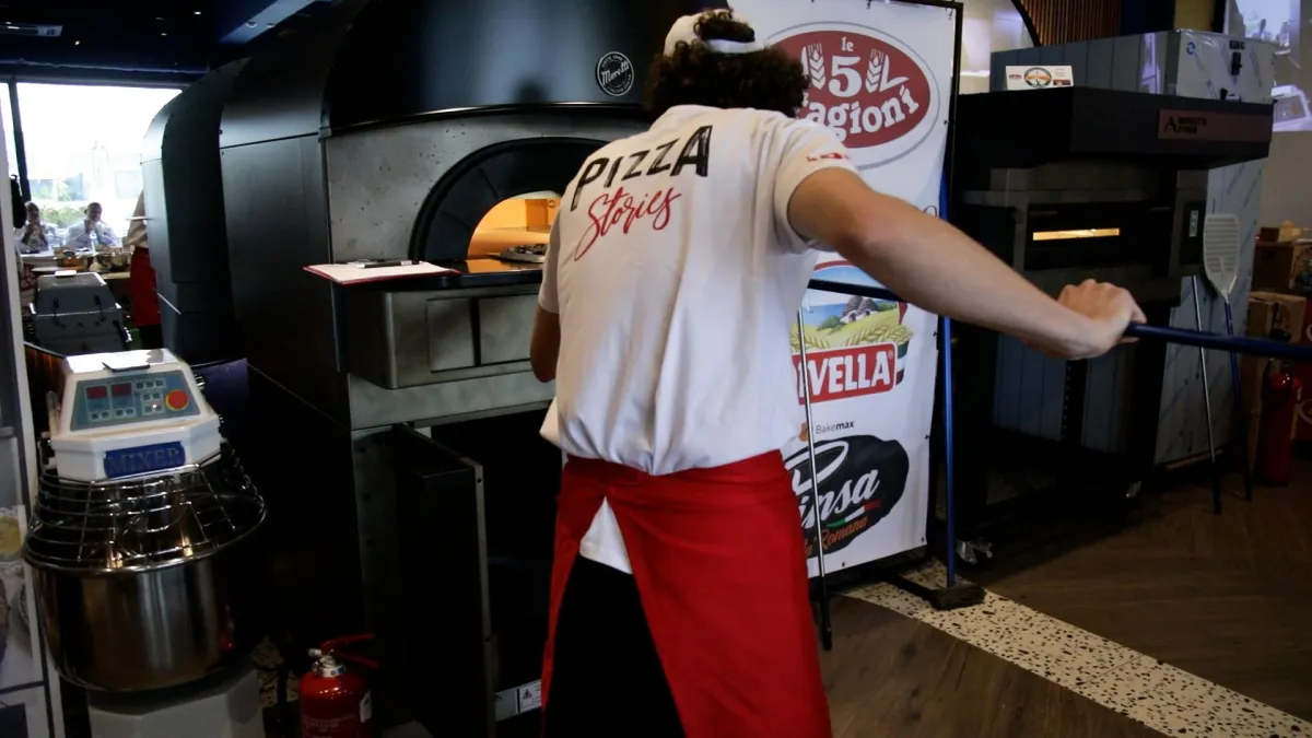 a sign that says pizza on a wooden table