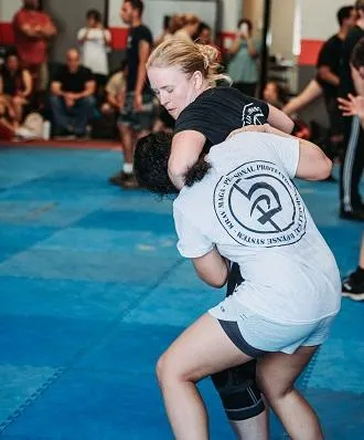 Krav Maga LKN instructor applying headlock to student, illustrating common real-world attack.