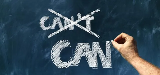 Can and can't written on an old style blackboard with can't crossed out and can written in clear.