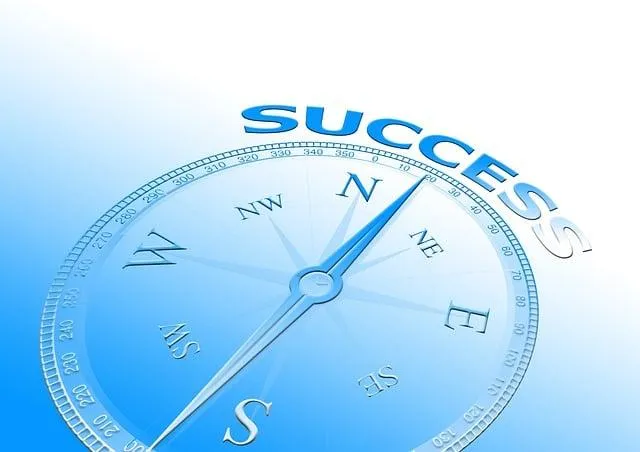 A beautiful blue compass with north pointing to the word success