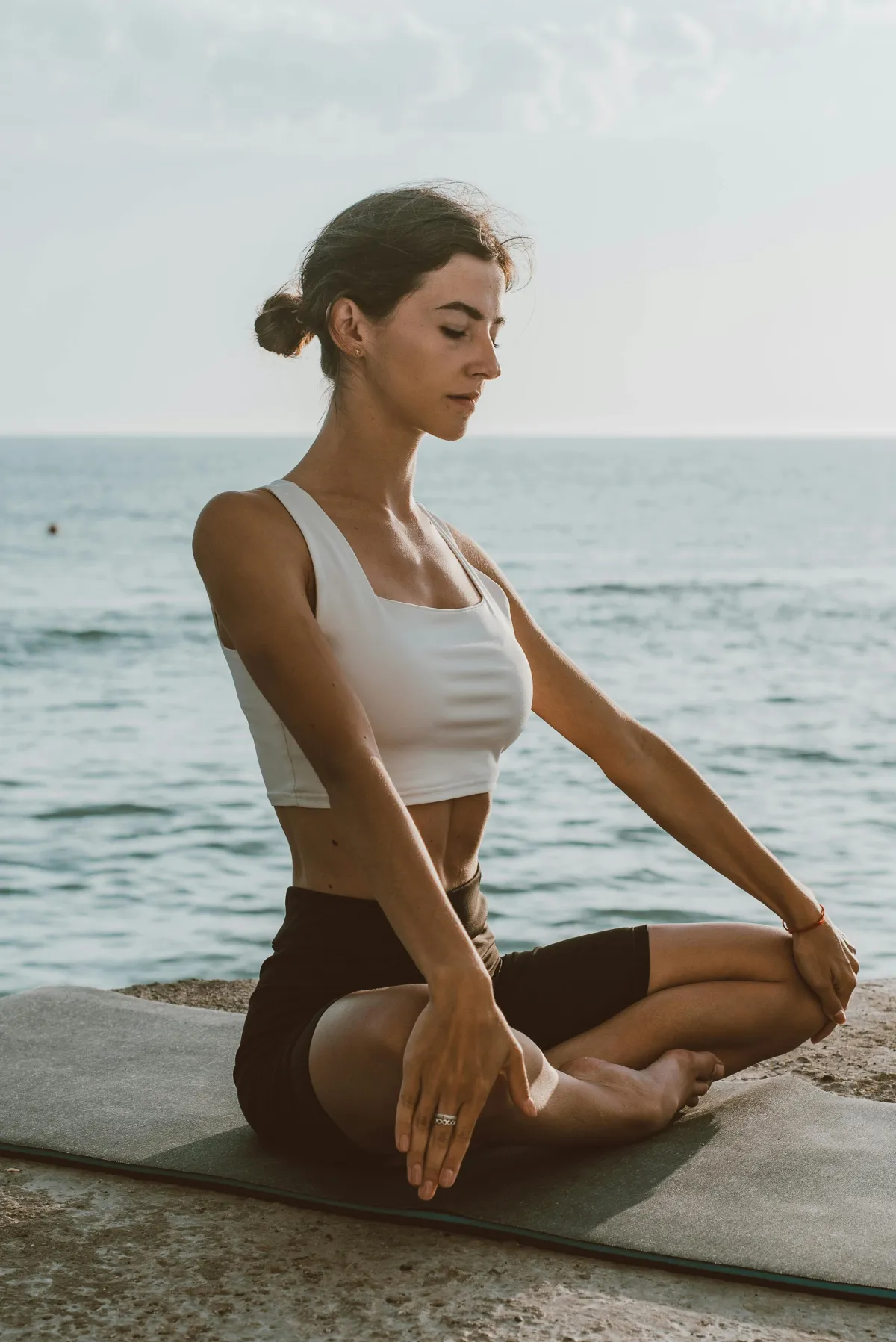 A woman meditation on a beach