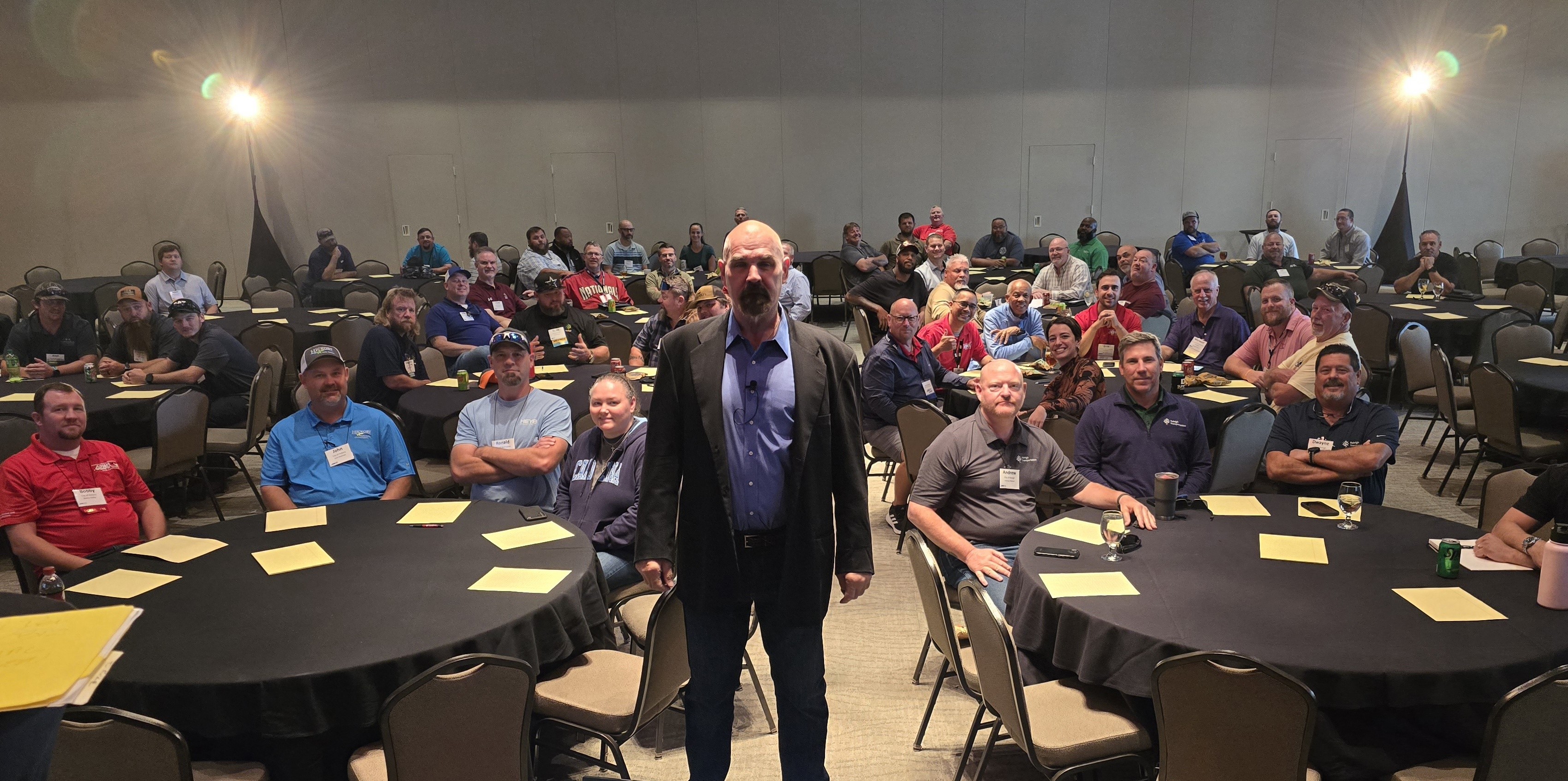 Nick Hughes speaking to a large group at a live public speaking and mindset event