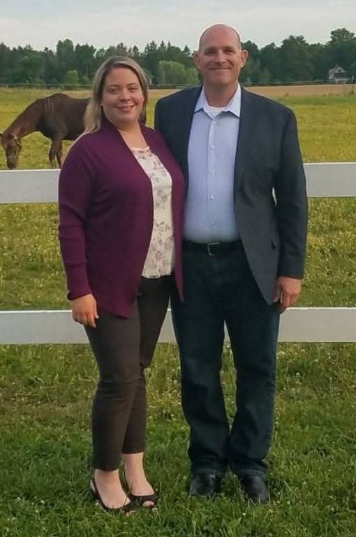 Soldiers walk through a desert landscape.