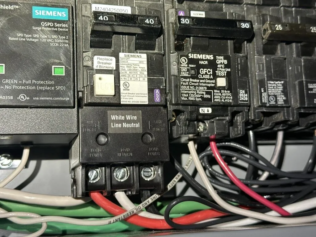 Close-up of circuit breakers being repaired by electrician for business operation