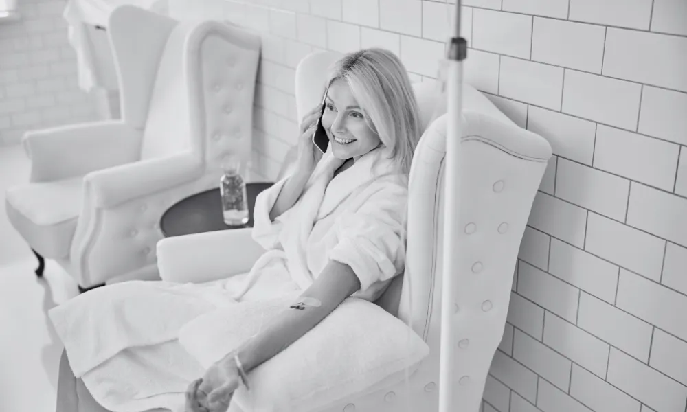 silhouette of person sitting on grass during sunset