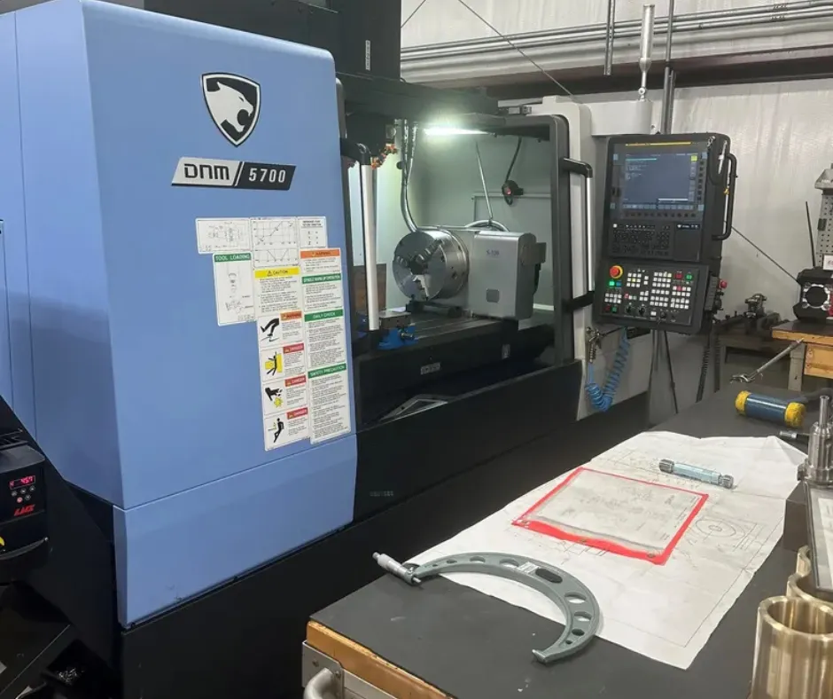 A 3D printer is shown in close-up detail.
