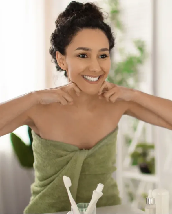 Aubree in a serene wellness space, demonstrating lymphatic flow techniques