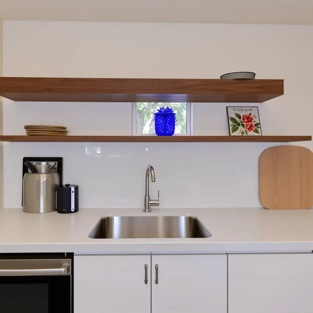 Modern renovated kitchen in West Grove Valley, CA with granite countertops, wood cabinets, stainless steel appliances, and large windows.