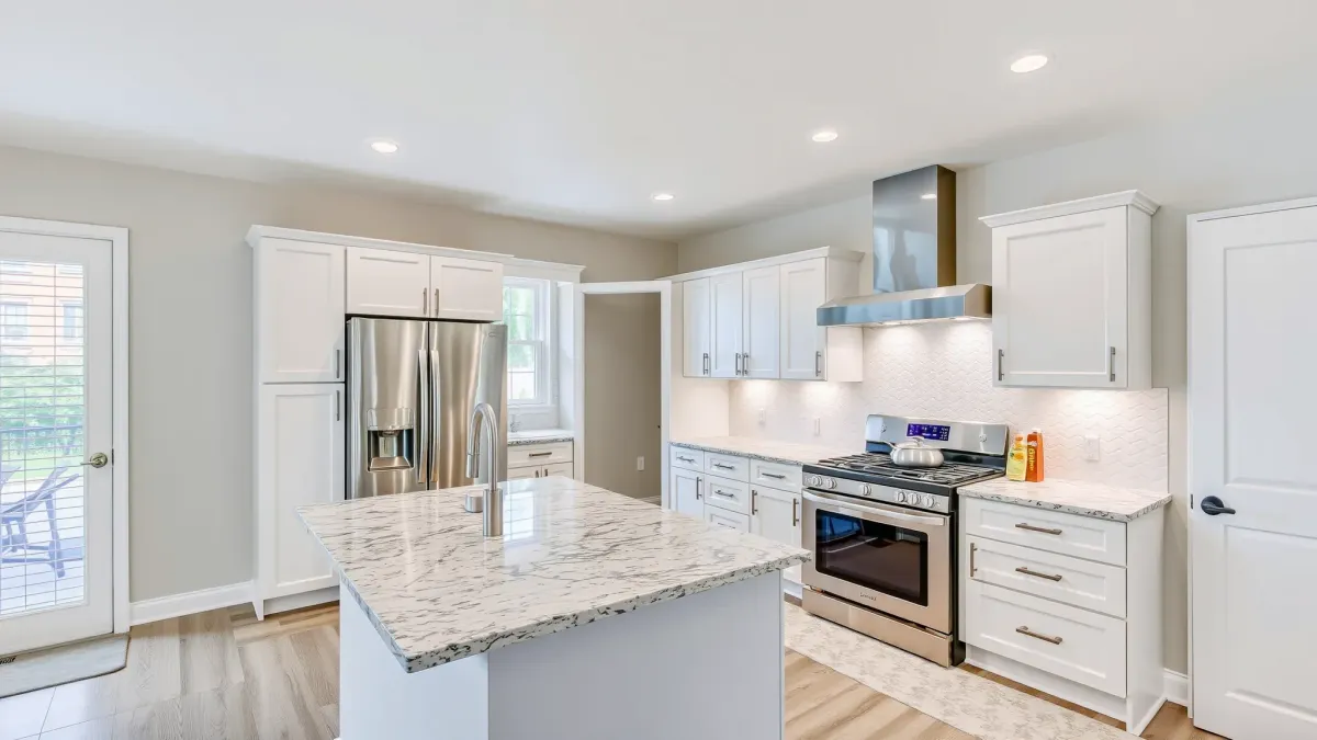 Remodeled Santa Ana kitchen with warm wood cabinetry, granite island, stainless appliances, city views, and sleek decor.