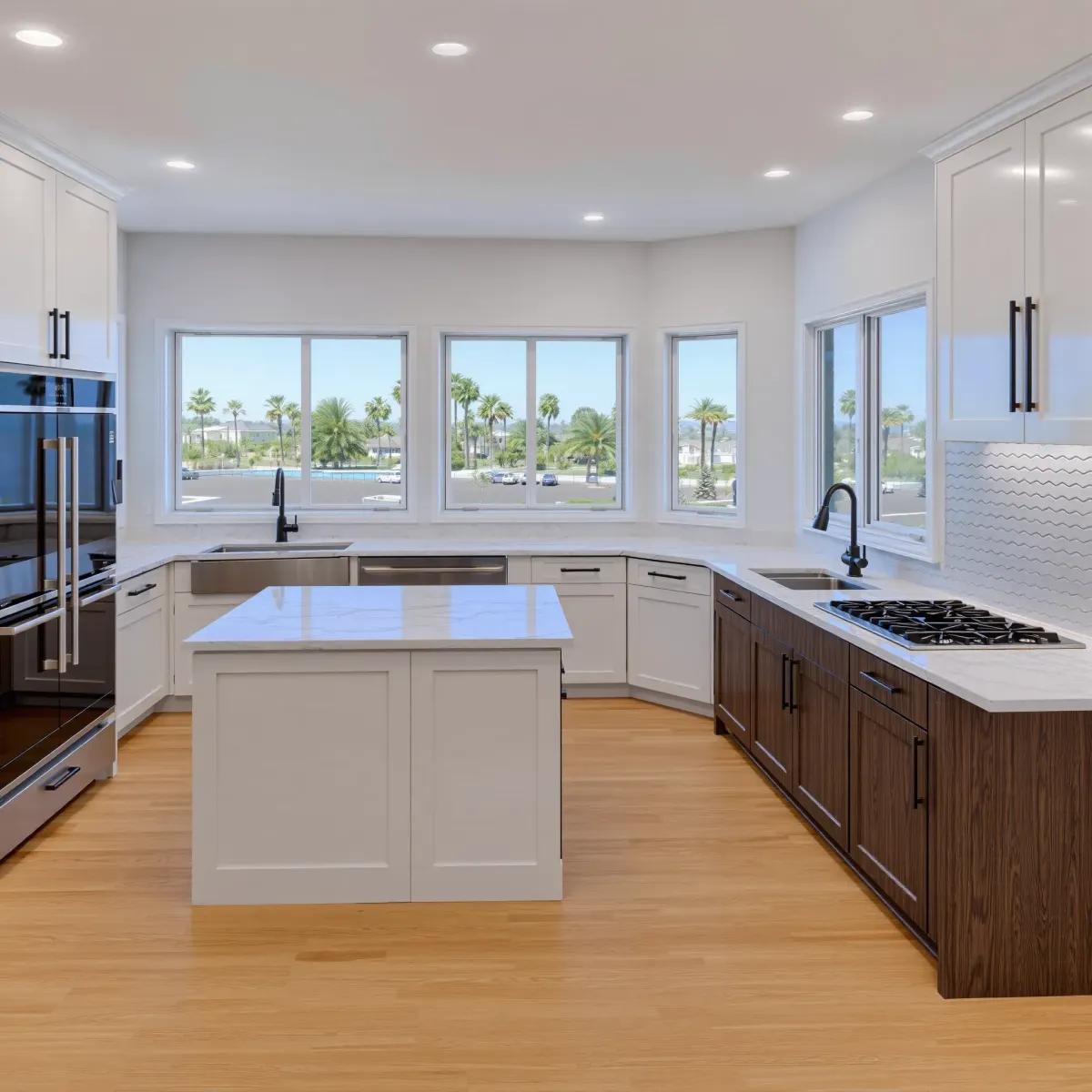 Remodeled Newport Coast kitchen with modern neutral cabinetry, quartz countertops, large island, stainless steel appliances, and ocean view.