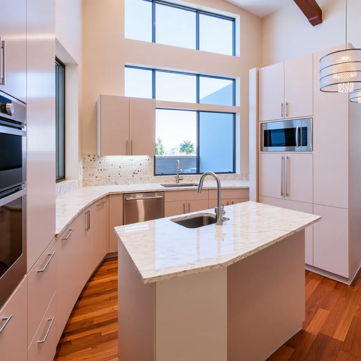 Remodeled Lake Forest, CA kitchen with warm wood cabinets, quartz countertops, stainless appliances, and large windows.