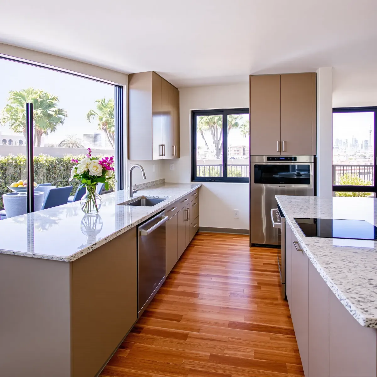 Modern Los Angeles kitchen with sleek cabinets, stainless appliances, granite counters, hardwood floors, and city views.
