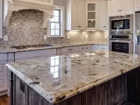 Renovated Los Angeles kitchen with marble countertops, stainless steel appliances, wooden cabinets, and sunlit open space.