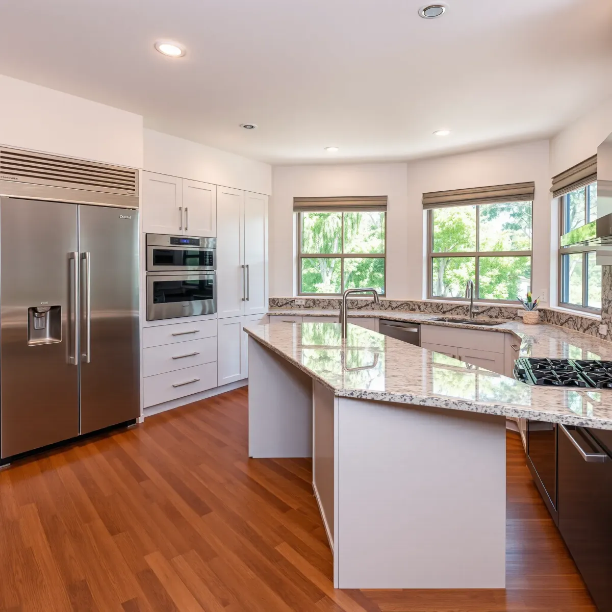 Remodeled Rancho Santa Margarita kitchen with sleek cabinetry, granite island, stainless appliances, hardwood floors, and lush outdoor views.