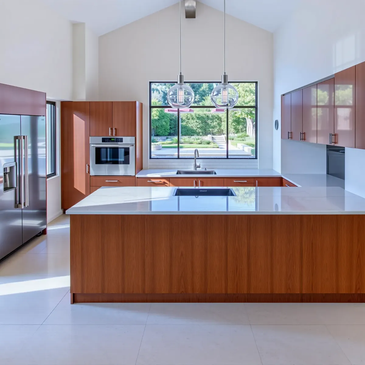 Modern Dana Point kitchen with stainless steel appliances, quartz countertops, warm wood cabinetry, coastal views, and elegant coastal decor.