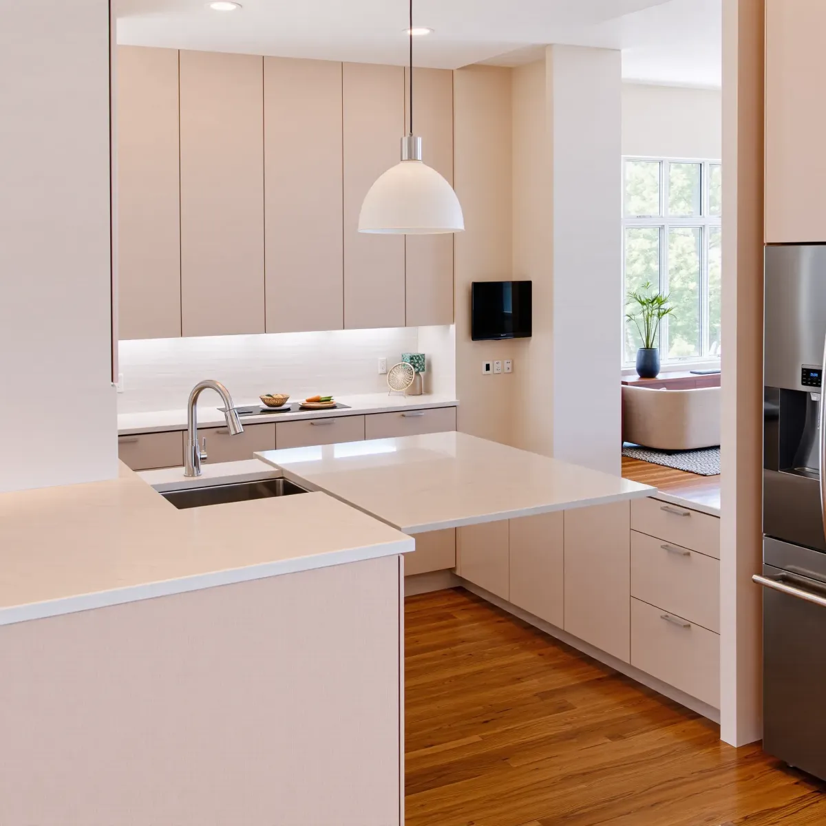Recently renovated Mid-City, CA kitchen with sleek wood cabinetry, marble countertops, stainless steel appliances, and garden views.