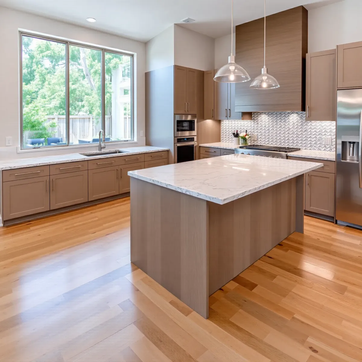 Remodeled Santa Anita Park kitchen with modern oak cabinetry, stainless appliances, quartz island, and lush greenery view.