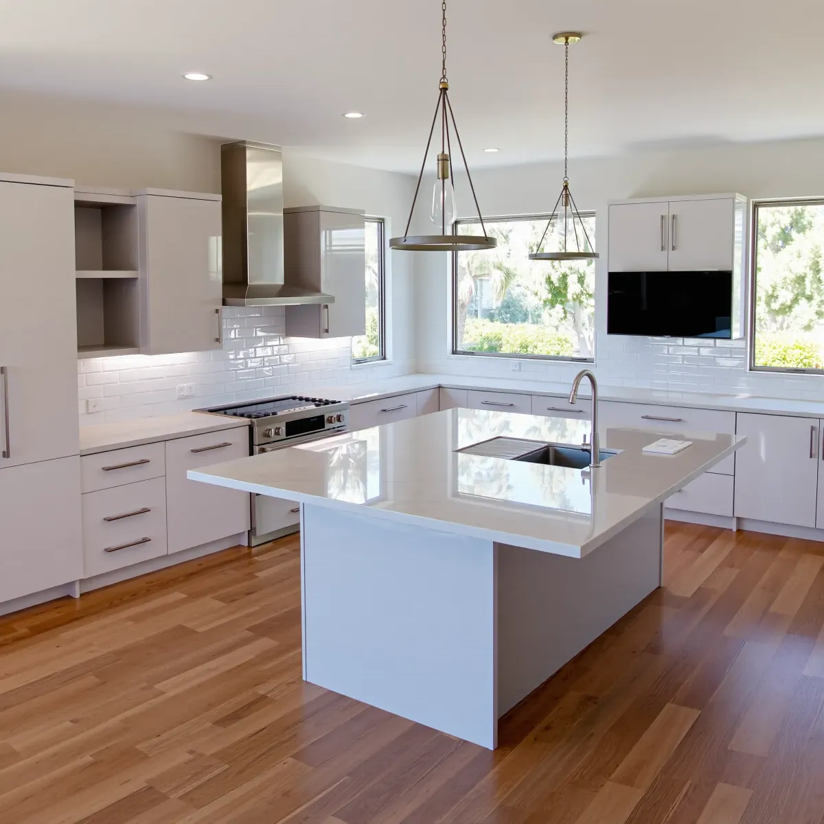 Remodeled Newport Coast kitchen with modern wood cabinets, white quartz countertops, stainless appliances, and coastal views.