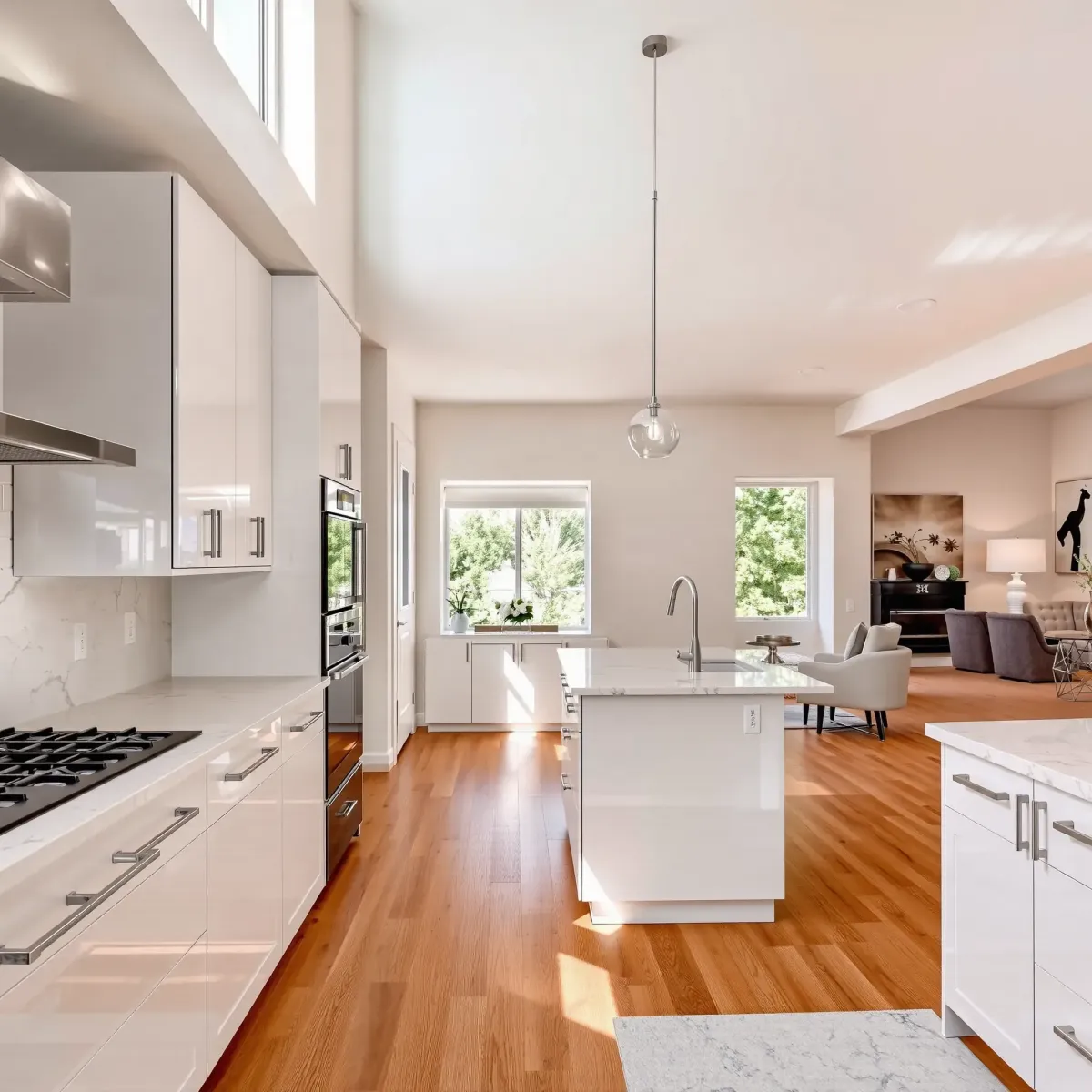 Remodeled Rancho Santa Margarita kitchen with white cabinetry, quartz countertops, marble backsplash, hardwood floors, and ample natural light.